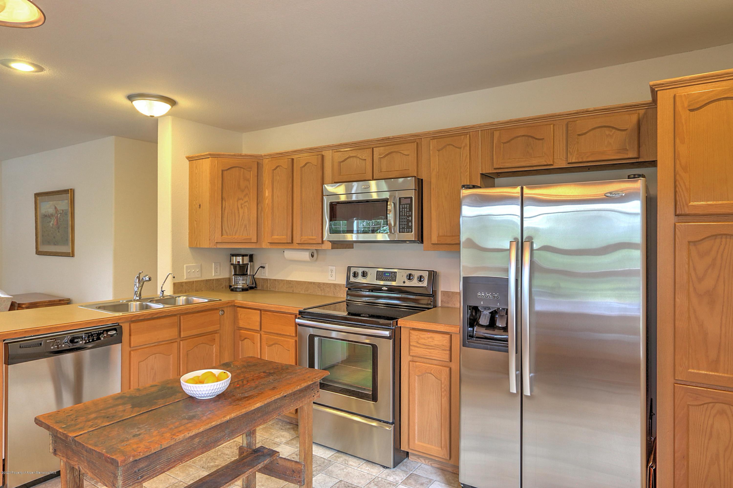 3045 Highway 325 Rifle, CO 81650 - Photo 10 of 35 a kitchen with a refrigerator a stove a sink and a cabinets
