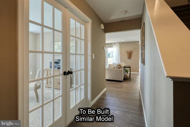 a view of a hallway with a livingroom and furniture