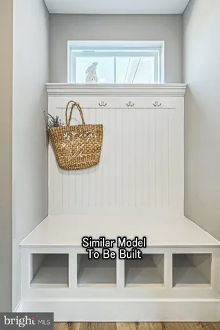 a view of a utility room with cabinet and a window