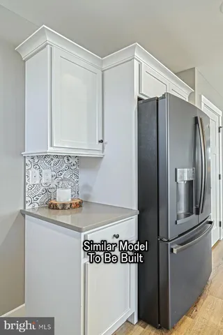 a kitchen with metallic refrigerator freezer and a dishwasher