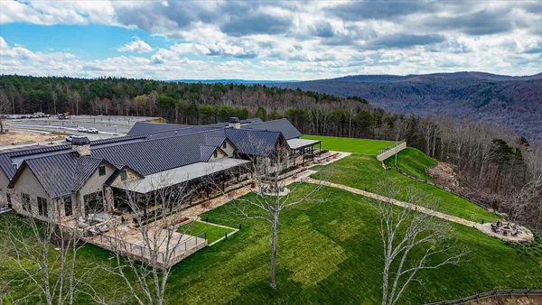 an aerial view of a house with a big yard