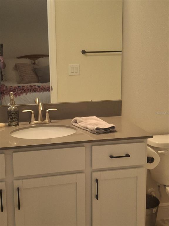 12618 Vander Way New Port Richey, FL 34654 - Photo 16 of 22 a bathroom with a sink and a mirror