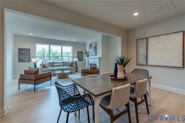 a dining room with furniture and wooden floor