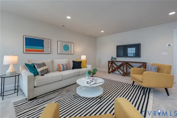 a living room with furniture and a rug