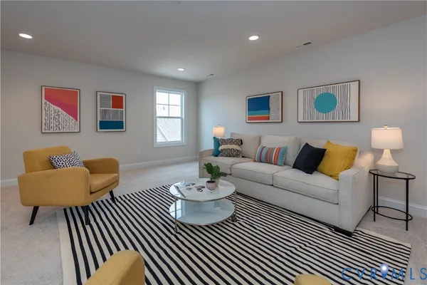 a living room with furniture and a rug