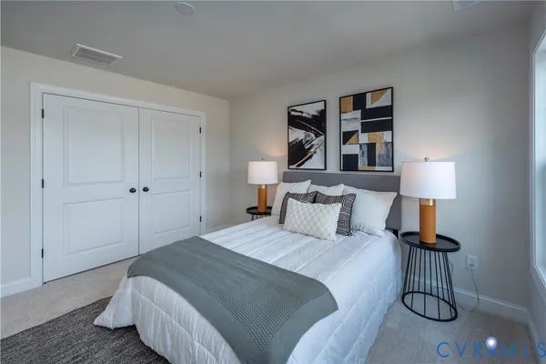 a bedroom with a bed and a lamp