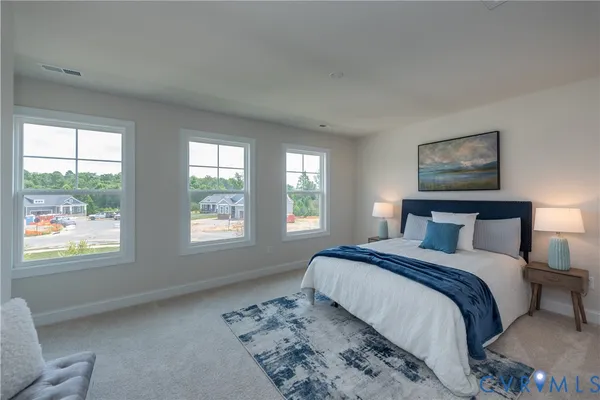 a spacious bedroom with a large bed and two windows