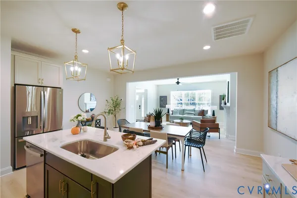 a kitchen with a stove a sink a dining table and chairs