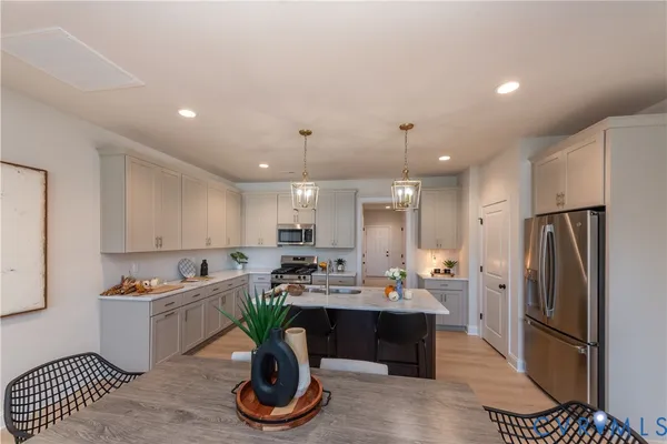 a kitchen with a sink appliances and cabinets
