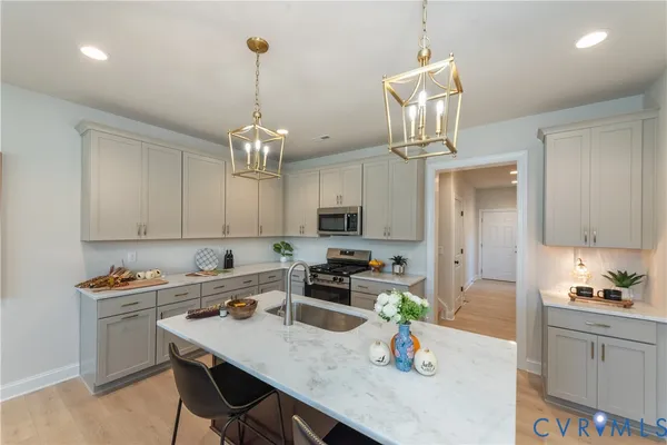a kitchen with a dining table chairs and white cabinets
