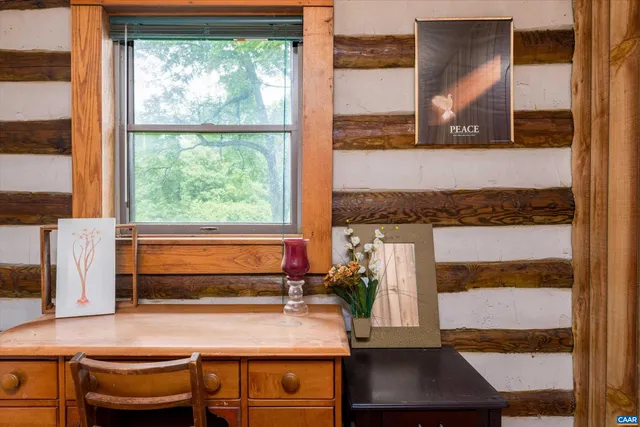 a backyard of a house with table and chairs under an umbrella