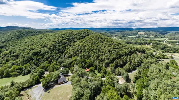 a backyard of a house with lots of green space and fountain