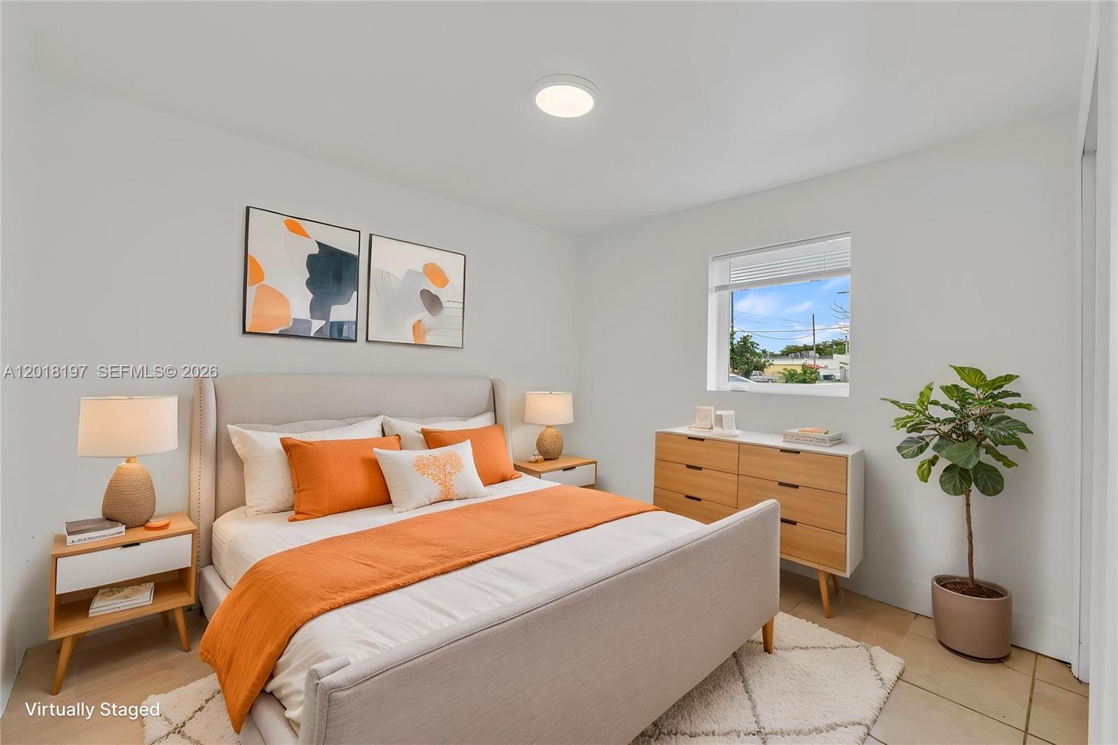 628 Southwest 8th Avenue Homestead, FL 33030 - Photo 10 of 25 a bedroom with a bed and a potted plant