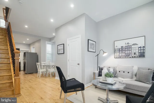 a living room with furniture and kitchen view