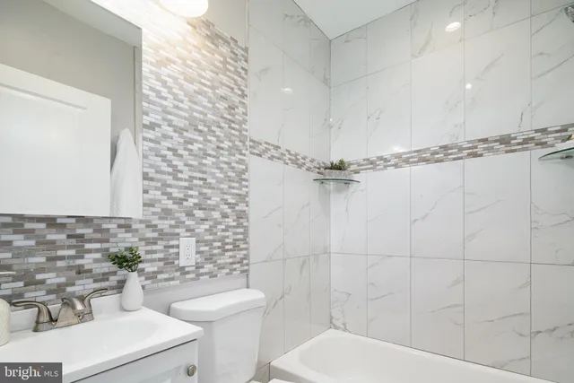 a bathroom with a toilet a sink and a shower