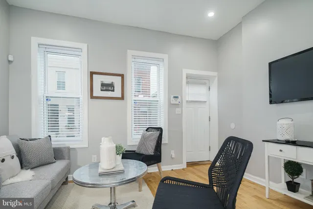 a work room with furniture wooden floor and windows