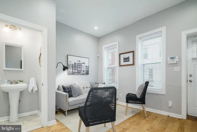 a living room with furniture a rug and a window