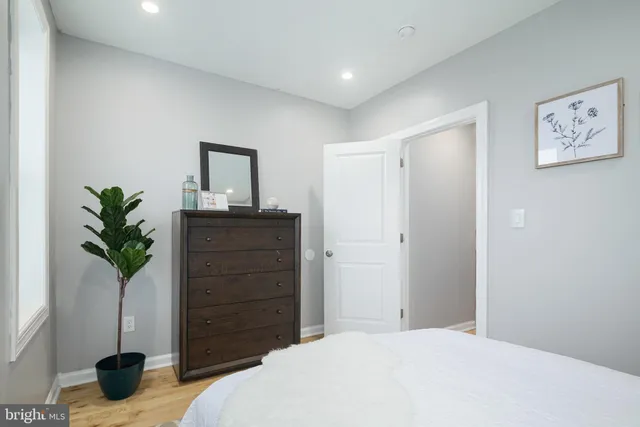 a bedroom with a bed and a potted plant