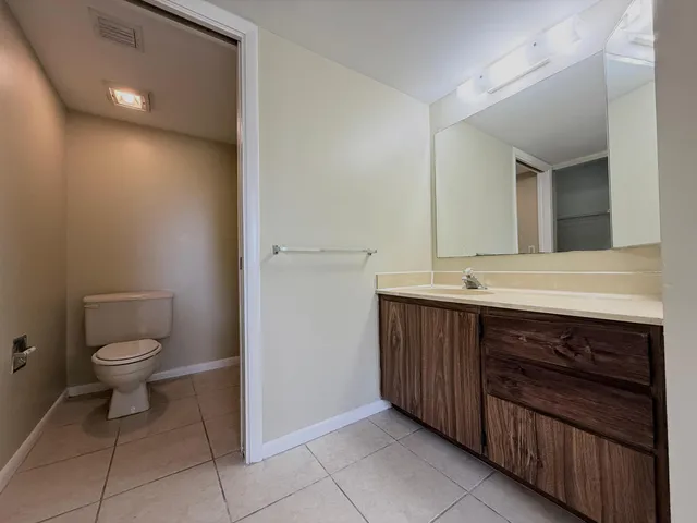 a bathroom with a sink a toilet and mirror