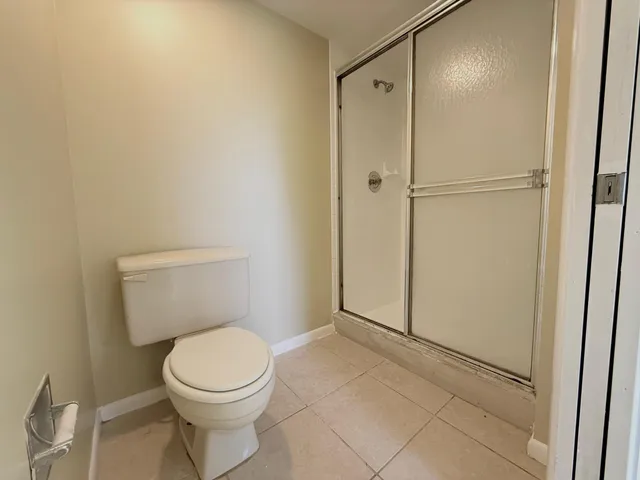 a bathroom with a toilet and a shower