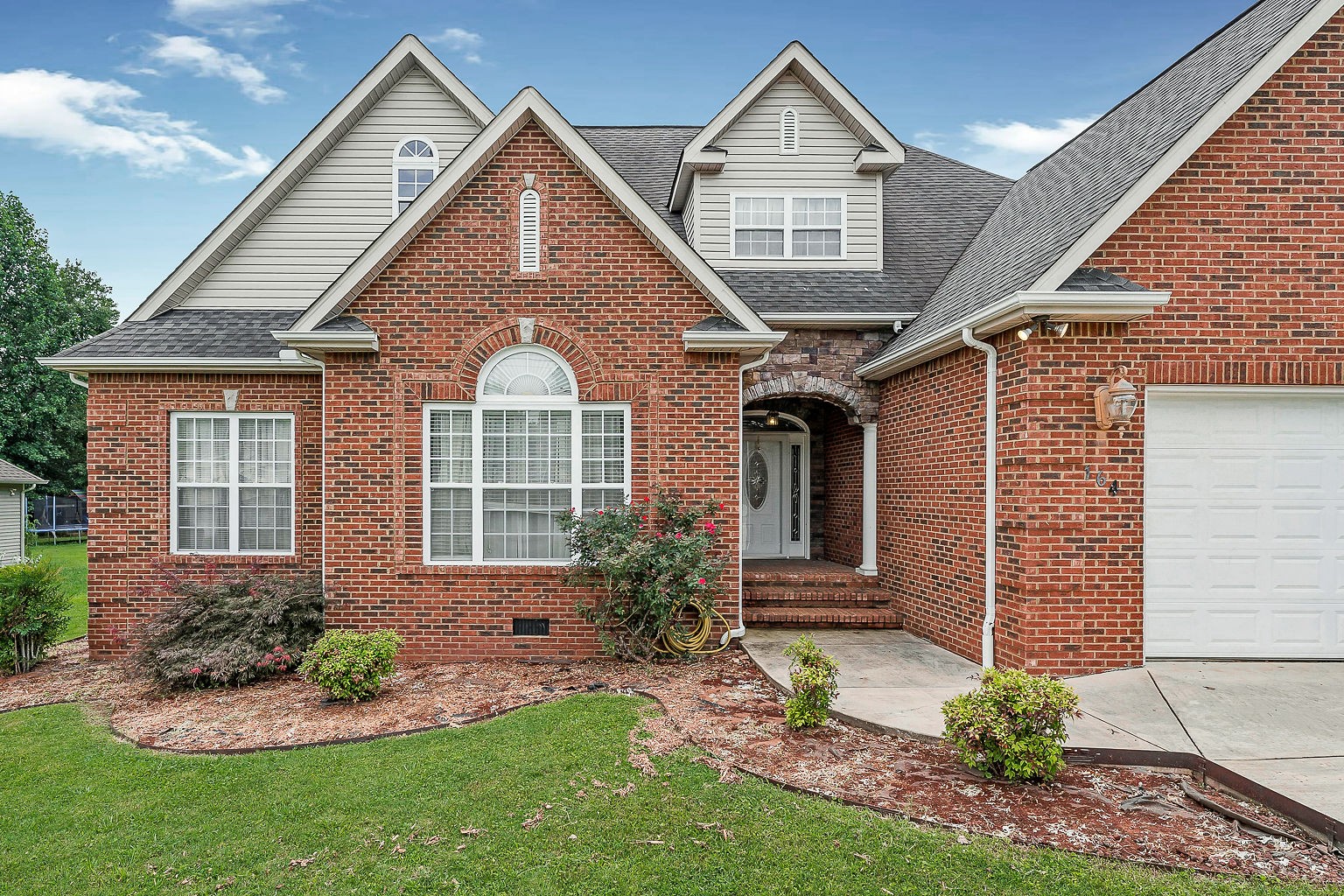 164 Simons Boulevard Morrison, TN 37357 - Photo 2 of 16 a front view of a house with a garden