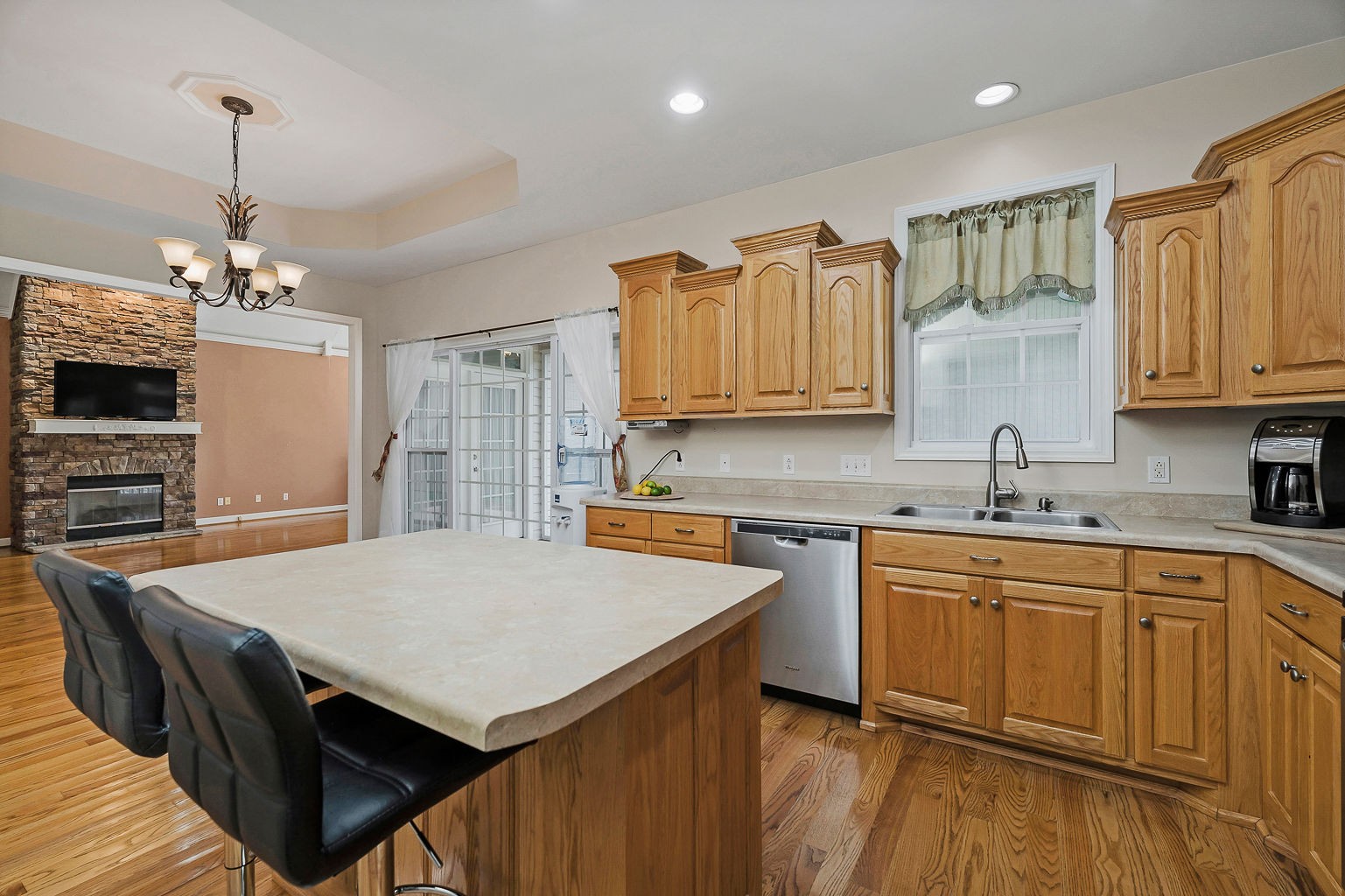 164 Simons Boulevard Morrison, TN 37357 - Photo 3 of 16 a kitchen with a stove a sink dishwasher a kitchen island with wooden cabinets and chairs
