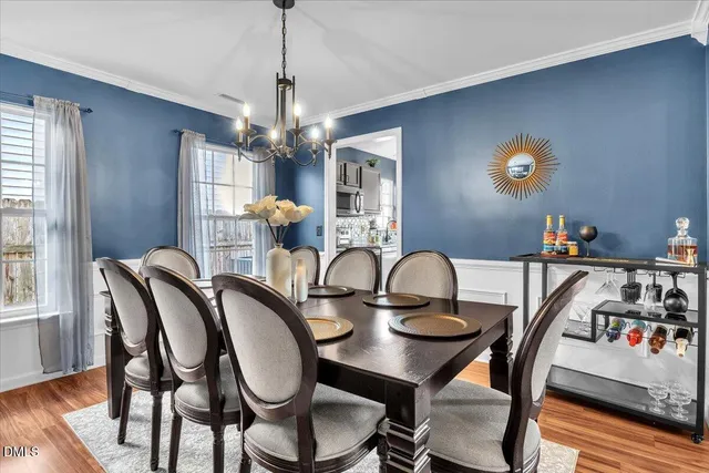 a view of a dining room with furniture and wooden floor