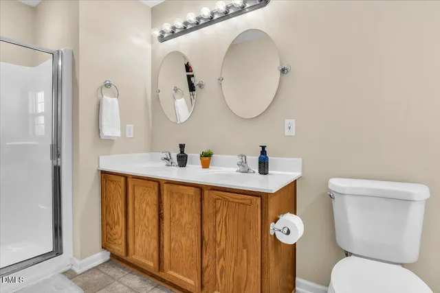 a bedroom with a bed and a lamp on dresser