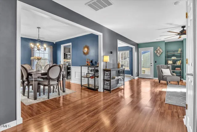 a view of a a dining room with furniture and wooden floor