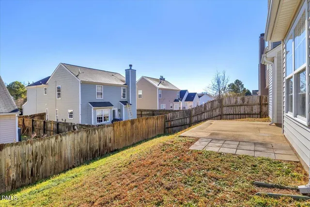 a view of a house with wooden fence