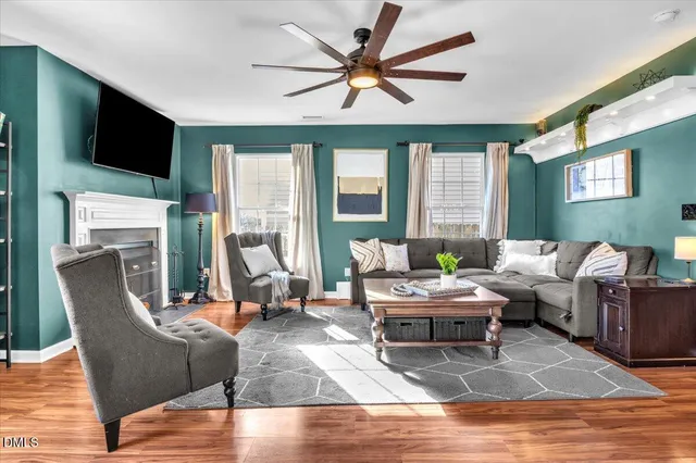 a living room with furniture a large window and a flat screen tv