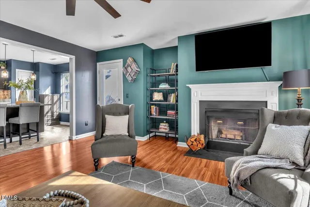a living room with furniture fireplace and flat screen tv