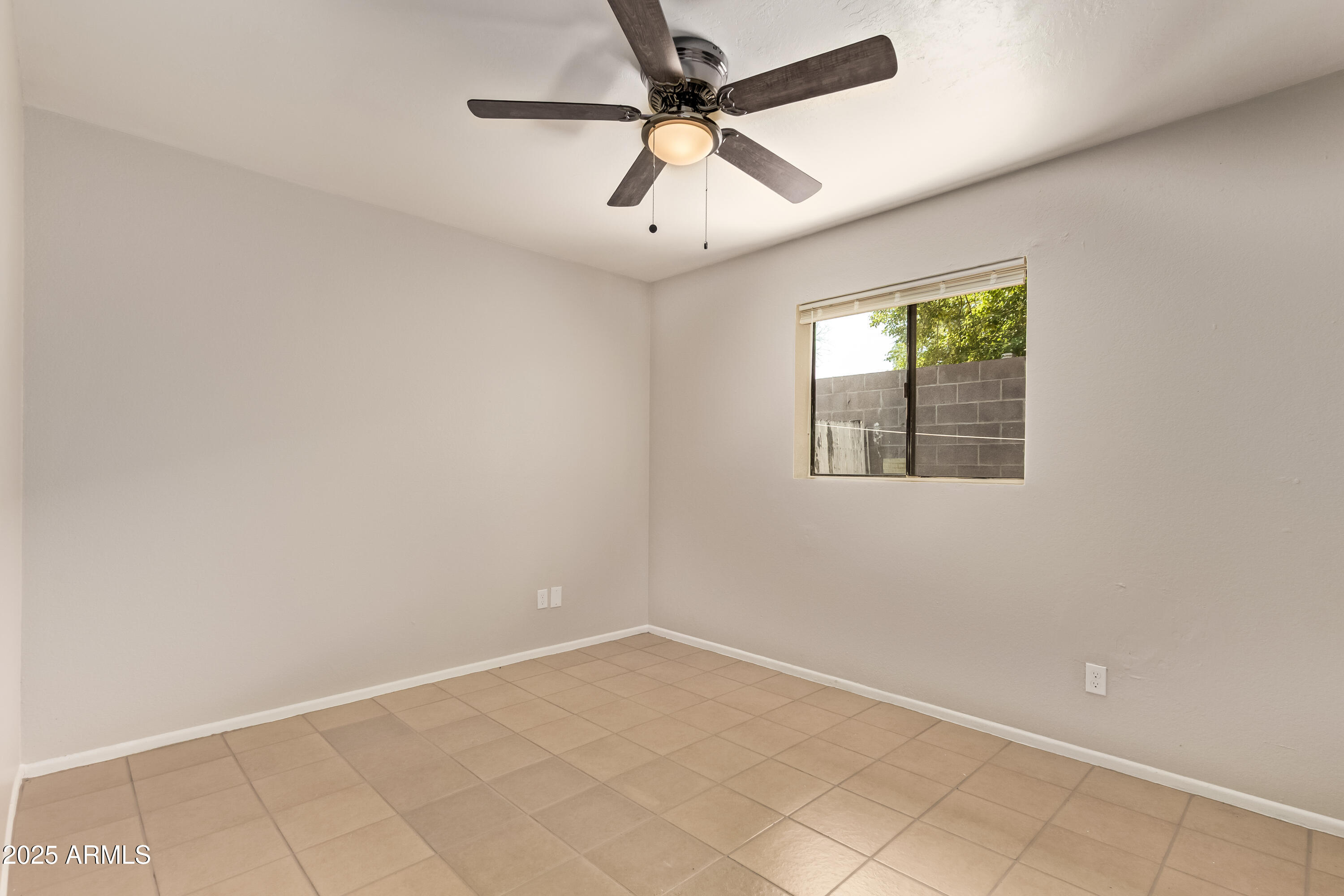 514 South Bellview, Unit 1 Mesa, AZ 85204 - Photo 11 of 21 an empty room with a window and a fan