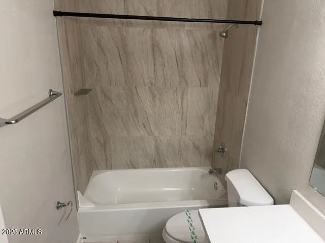 a bathroom with a bathtub and a toilet