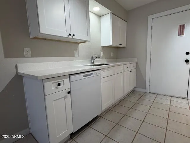 a kitchen with granite countertop white cabinets and sink