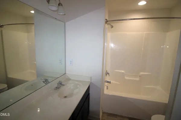a bathroom with a tub and a sink