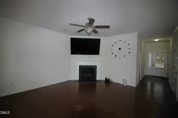a living room with a fireplace and a flat screen tv