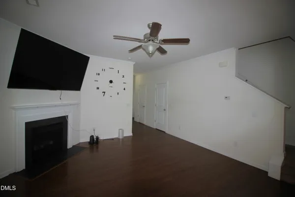 a living room with a fireplace and a flat screen tv