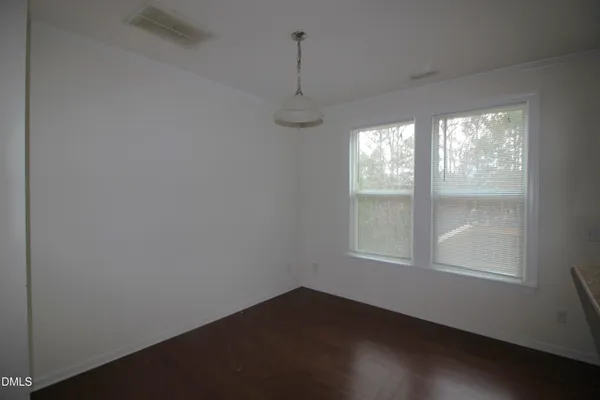 an empty room with windows and outdoor space