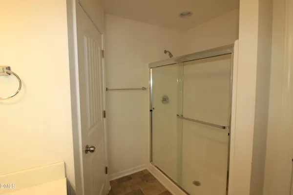 a bathroom with a shower and a sink