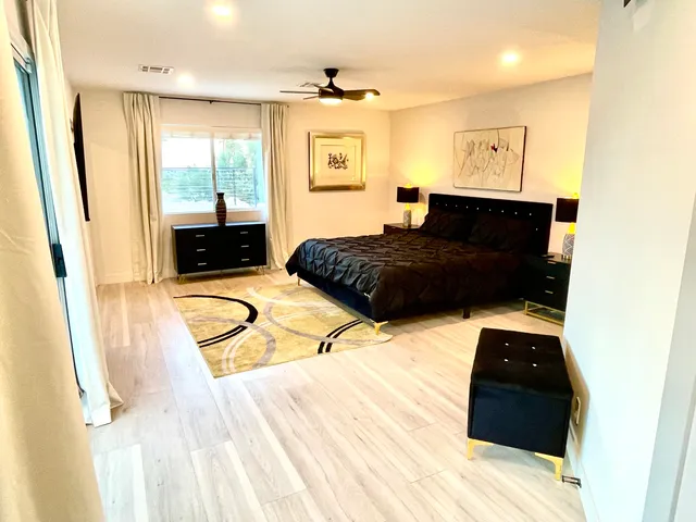 a bedroom with a bed window and a table