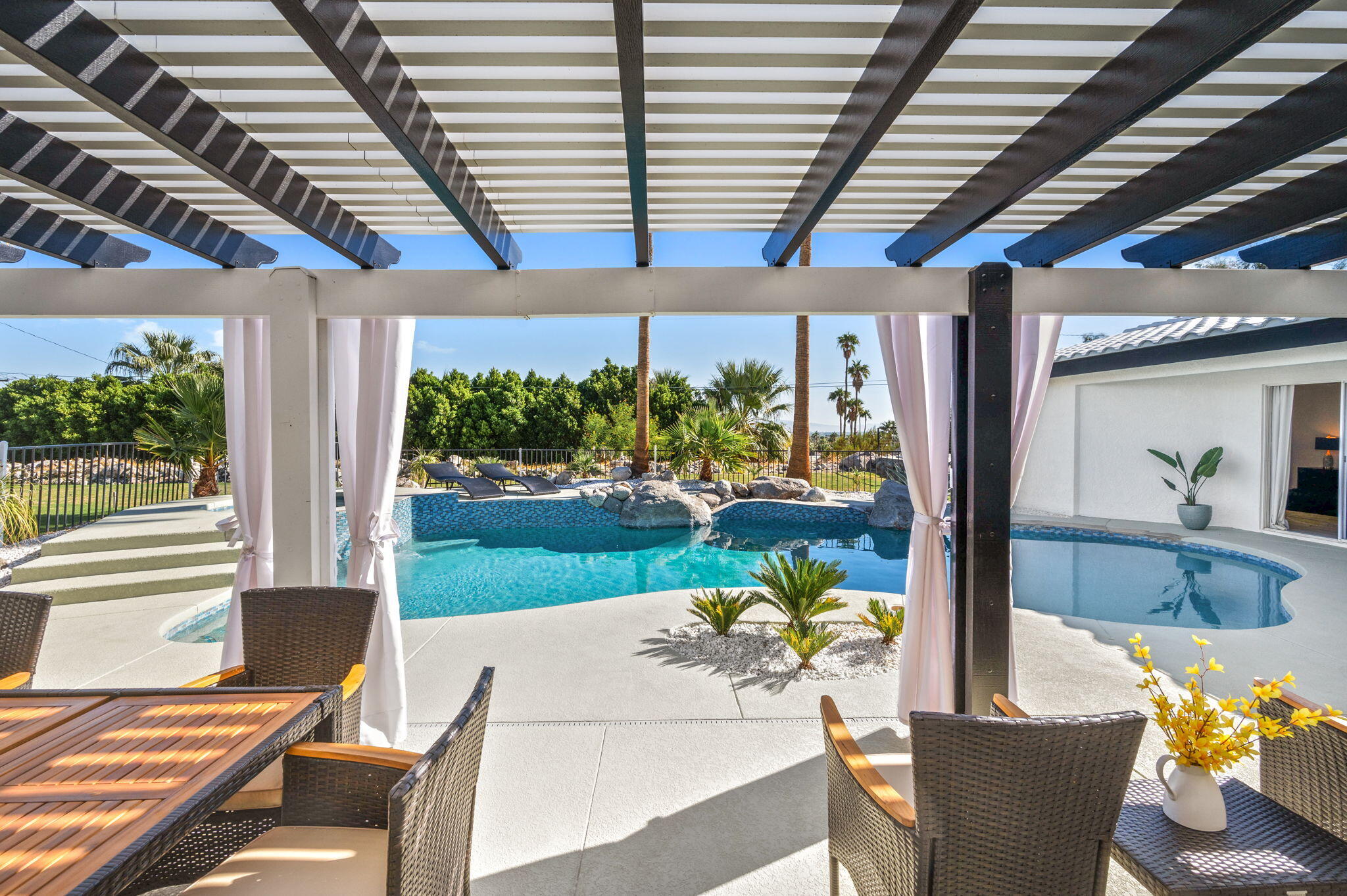 2380 North Leonard Road Palm Springs, CA 92262 - Photo 40 of 54 a view of a patio with table and chairs and potted plants