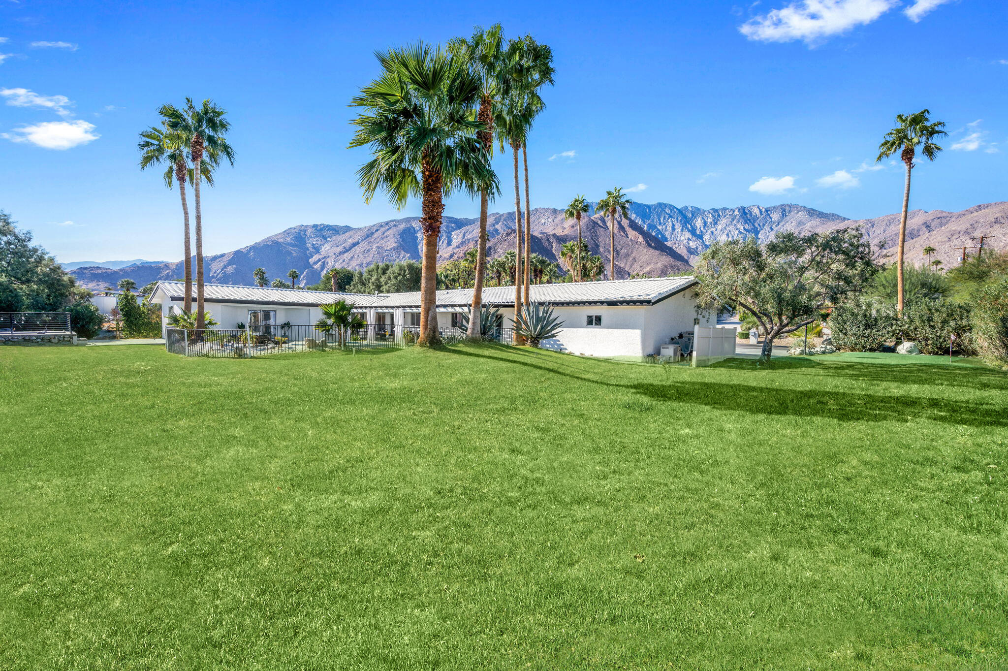 2380 North Leonard Road Palm Springs, CA 92262 - Photo 47 of 54 a view of a house with a garden and palm trees