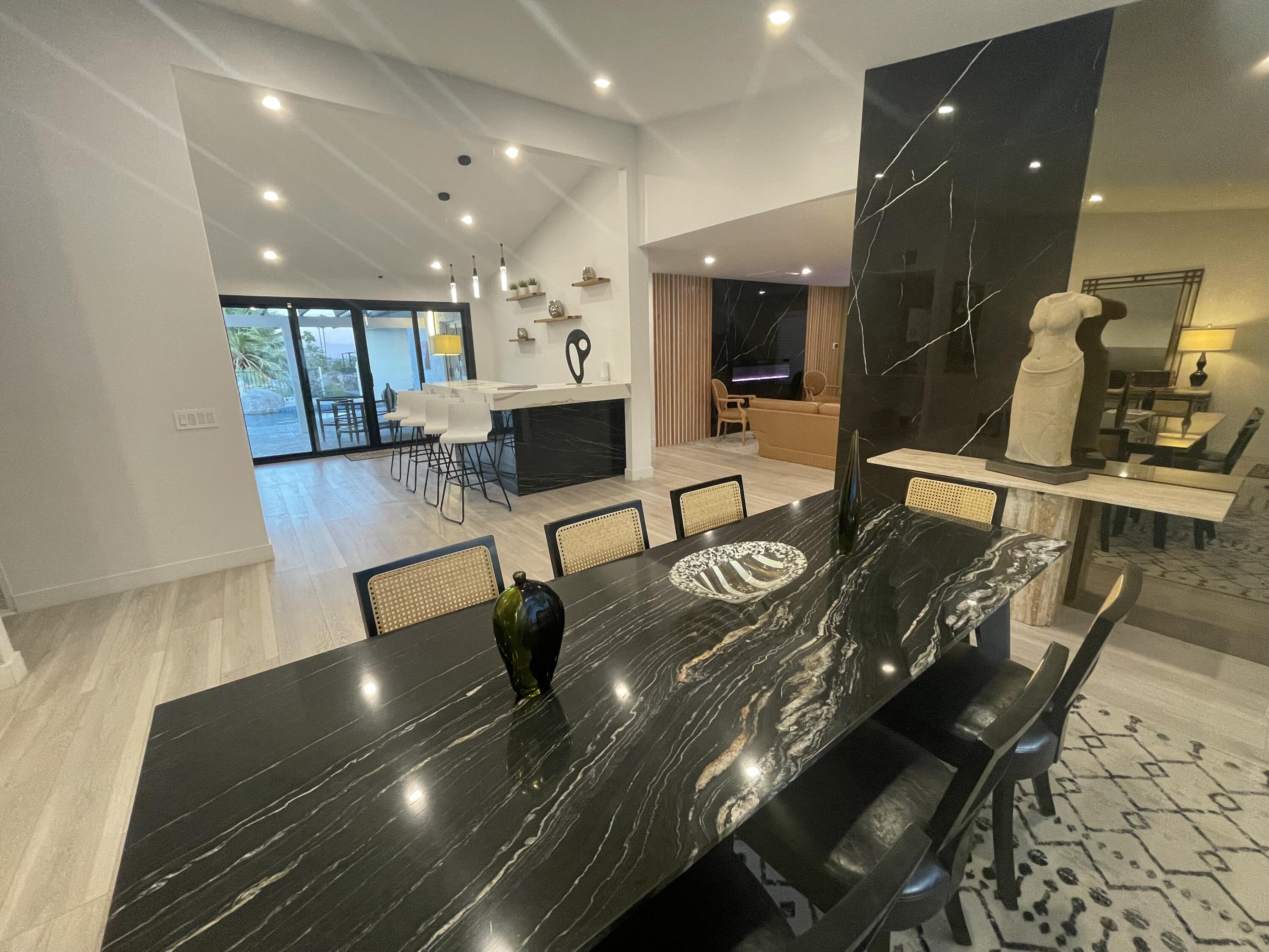 2380 North Leonard Road Palm Springs, CA 92262 - Photo 52 of 54 a view of a dining room with furniture a rug and wooden floor