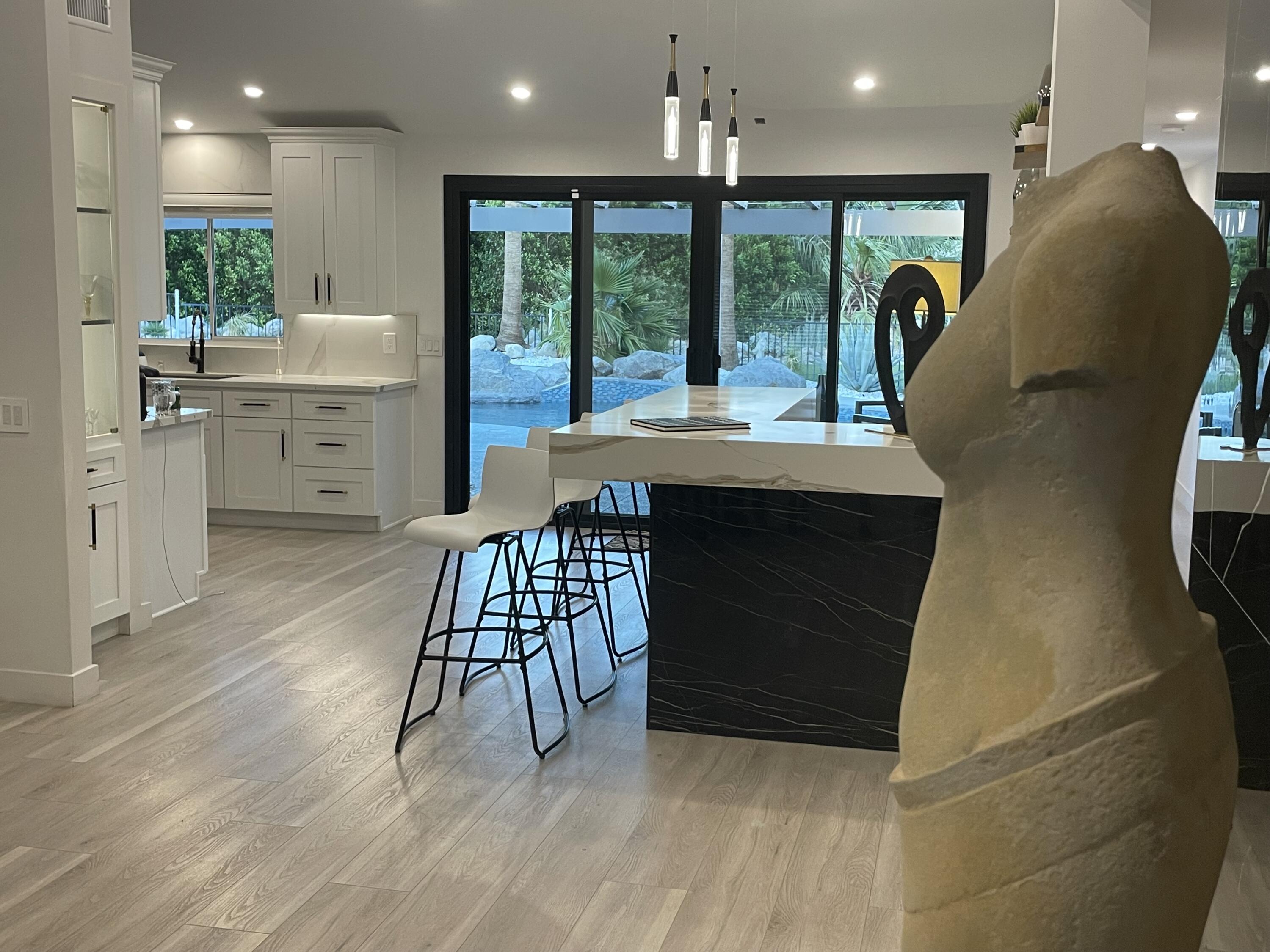 2380 North Leonard Road Palm Springs, CA 92262 - Photo 53 of 54 a view of a kitchen with kitchen island a large window a sink and a chandelier