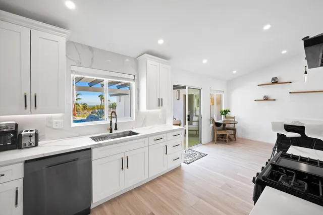 a kitchen with a sink appliances and cabinets