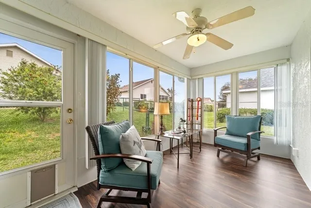 a living room with furniture and a floor to ceiling window