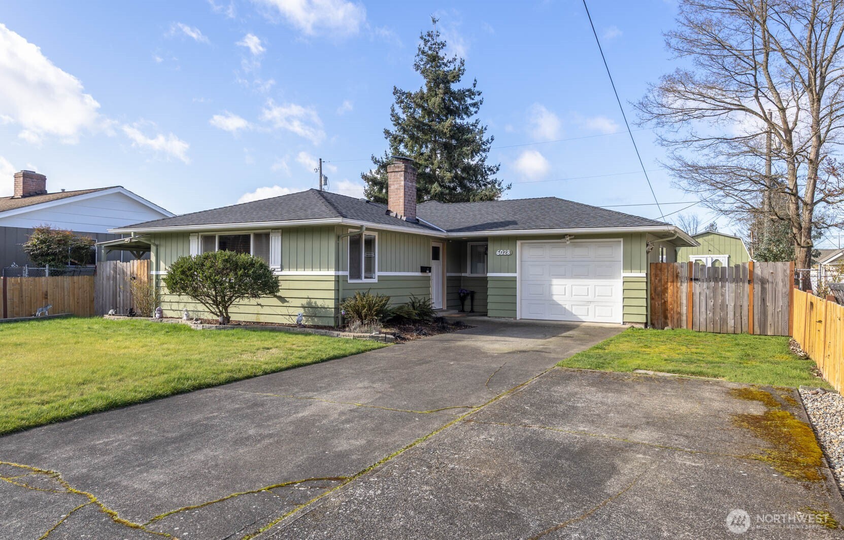 6028 South Prospect Street Tacoma, WA 98409 - Photo 1 of 32 a front view of a house with a yard and garage
