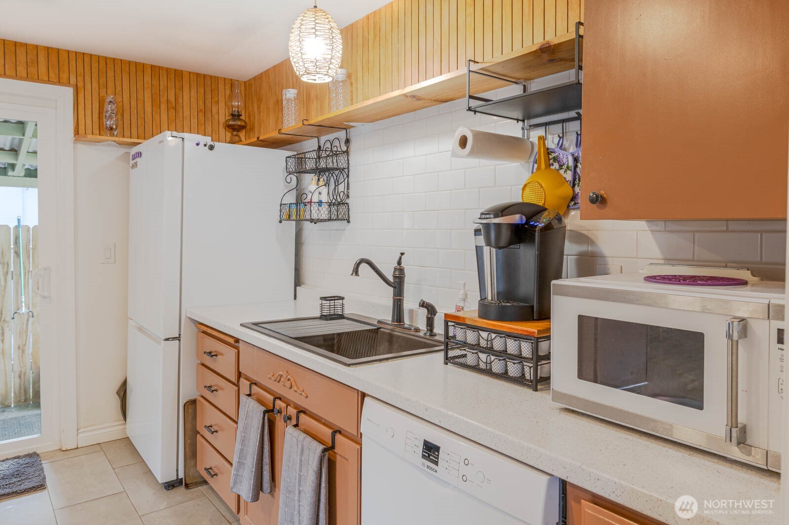 6028 South Prospect Street Tacoma, WA 98409 - Photo 13 of 32 a kitchen with stainless steel appliances granite countertop a sink stove and refrigerator