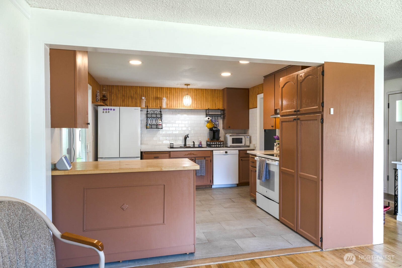 6028 South Prospect Street Tacoma, WA 98409 - Photo 7 of 32 a kitchen with stainless steel appliances granite countertop a refrigerator a sink and a stove